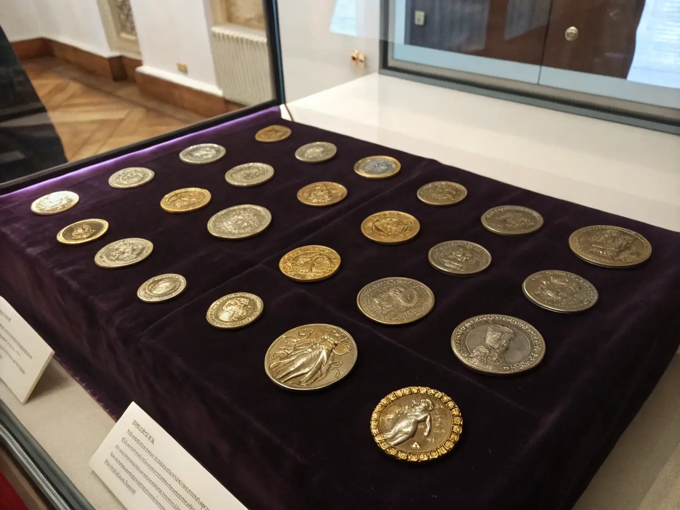 A detailed photograph of a collection of ancient Roman coins, showcasing the emperors' profiles and the symbols of the Roman Empire.